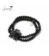 Zwarte armband met meerdere strengen en een bloemen bedel