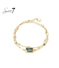 Armband goudkleurig met marmerlook groene steen en hartje