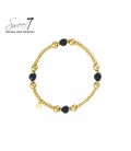 Goudkleurige armband met zwarte bolletjes
