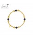 Goudkleurige armband met zwarte bolletjes